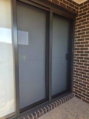 Cb: 81 Stacker Sliding Security Doors Fitted With Stainless Steel Mesh. Displaying The Two Security Doors In A Closed Position.