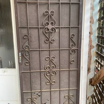 Door:-1 Brown Steel Security Door Before The Restoration.