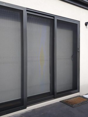 Cb: 57 Angle View Stacker Sliding Security Doors Fitted With Stainless Steel Mesh. Displaying The Two Security Doors In A Closed Position &Amp; The Third Security Fixed Panel Fitted With Tamper Proof Screws In Monument.stainless Steel Mesh Security Screen Doors Melbourne